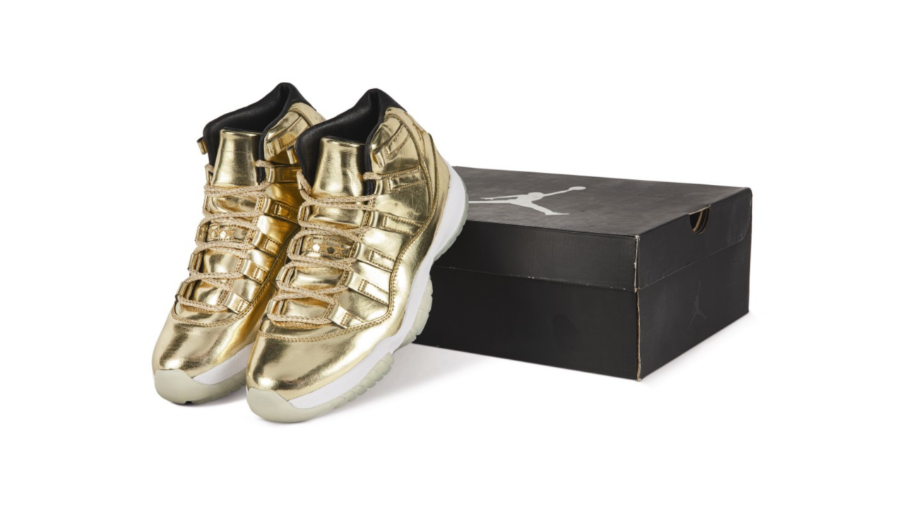 A rare pair of gold Nike Air Jordan XIs sneakers from the "Scarce Air" auction at Sotheby's