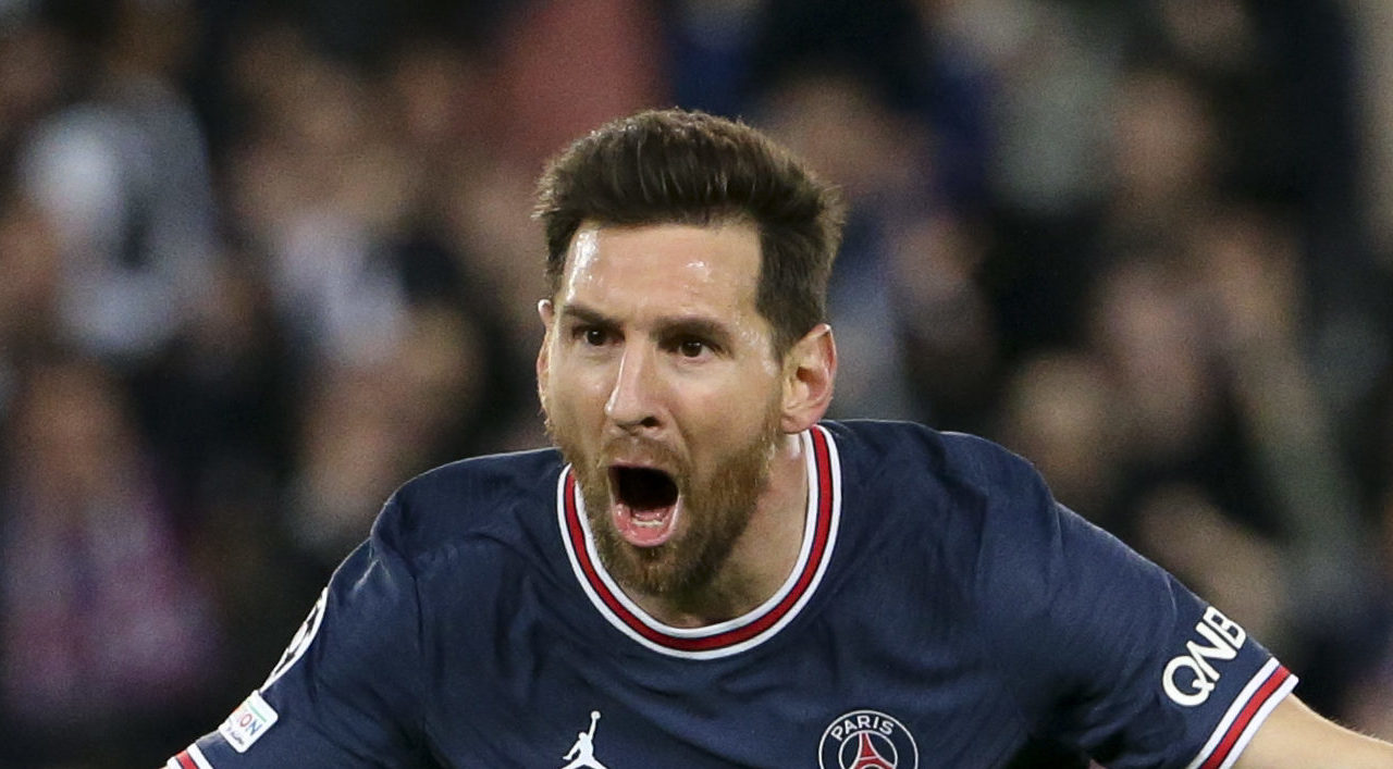 Soccer player Lionel Messi running with his arms spread celebrating a goal for Paris Saint-German