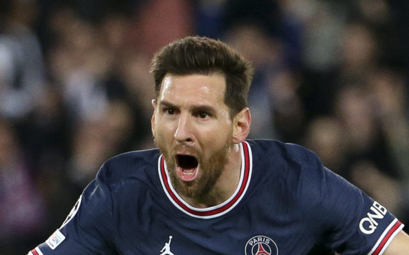 Soccer player Lionel Messi running with his arms spread celebrating a goal for Paris Saint-German