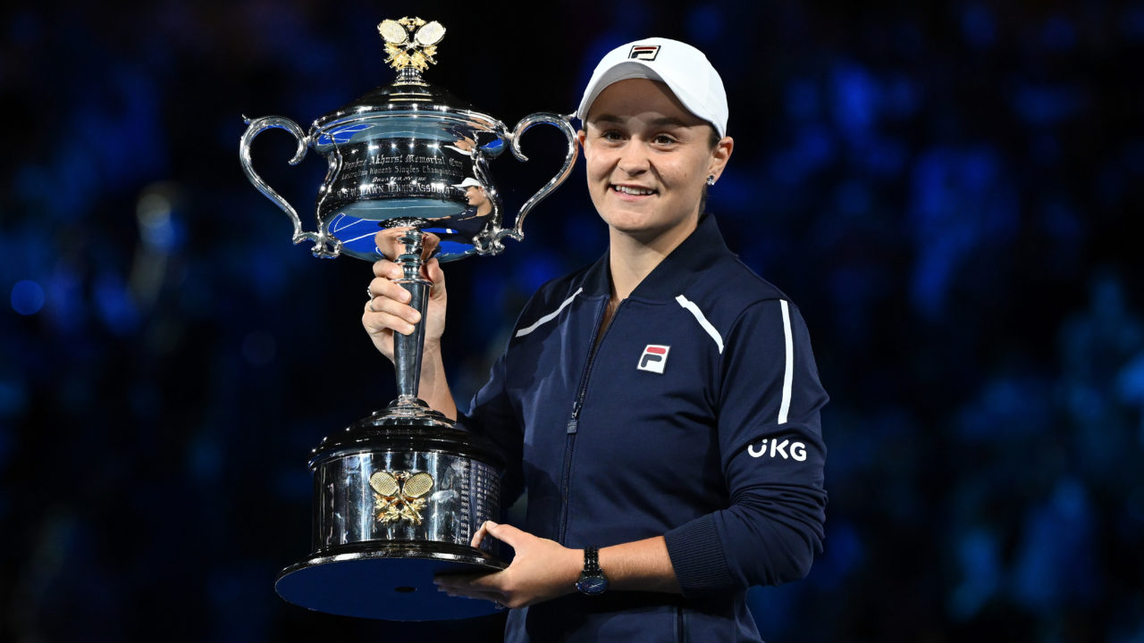Tennis player Ash Barty holding the at the crowd after winning the 2022 Australian Open trophy at Rod Laver Arena