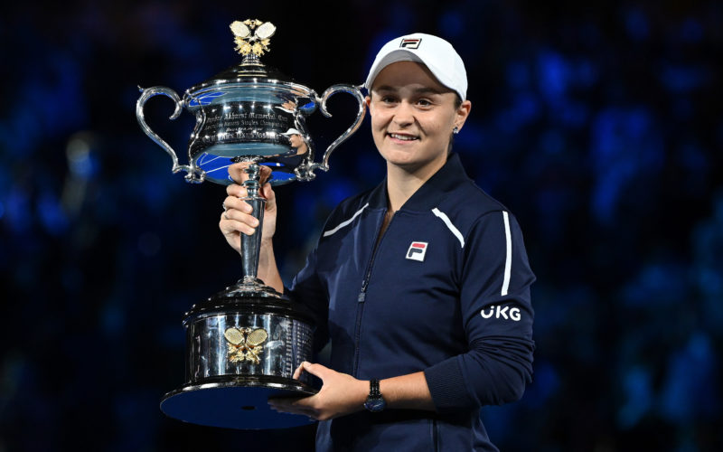 Tennis player Ash Barty holding the at the crowd after winning the 2022 Australian Open trophy at Rod Laver Arena