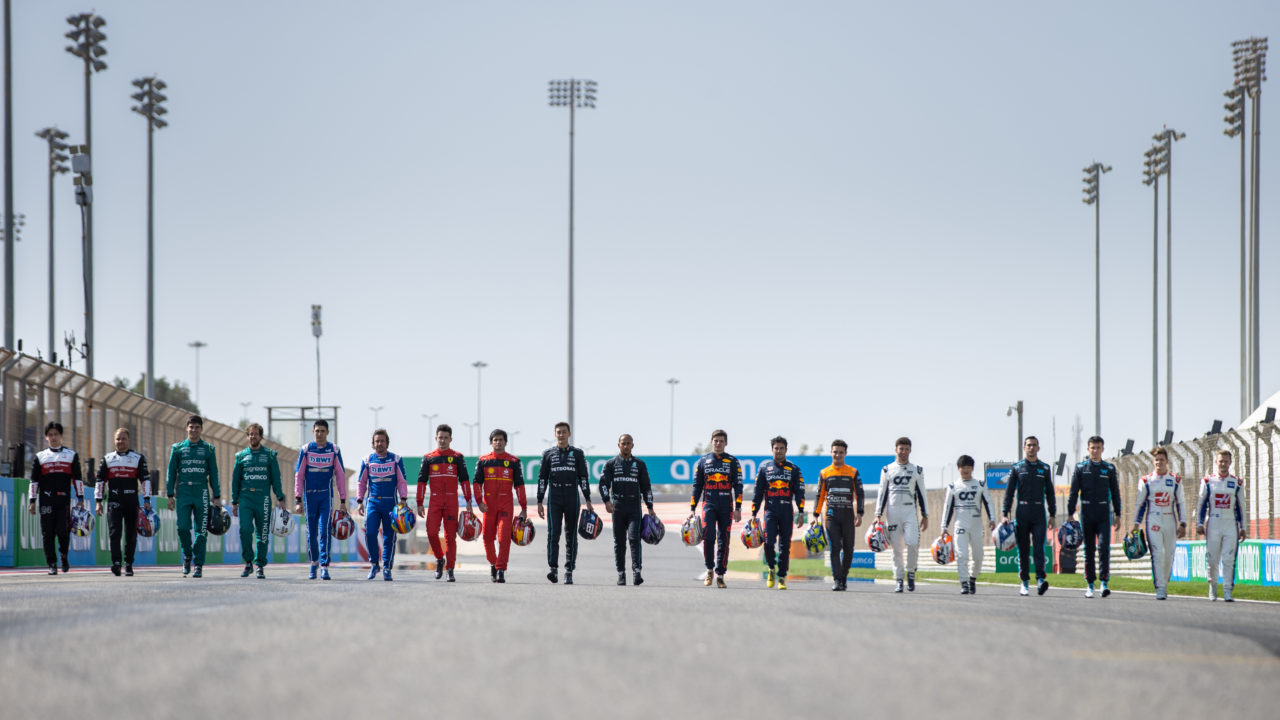 Formula 1 racing drivers walking side by side on the track at the Bahrain Grand Prix