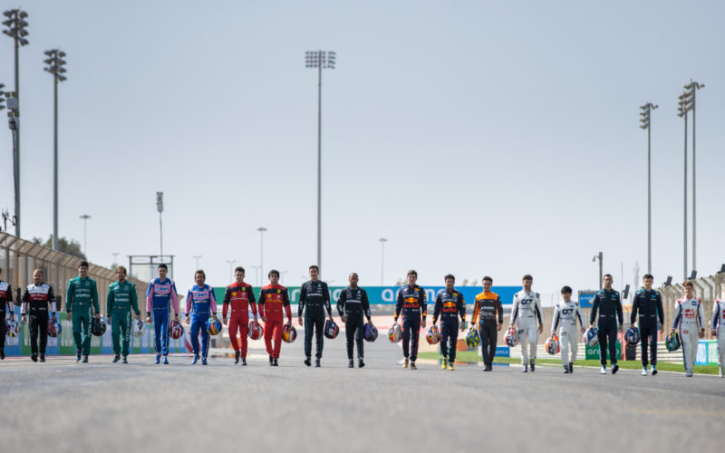 Formula 1 racing drivers walking side by side on the track at the Bahrain Grand Prix