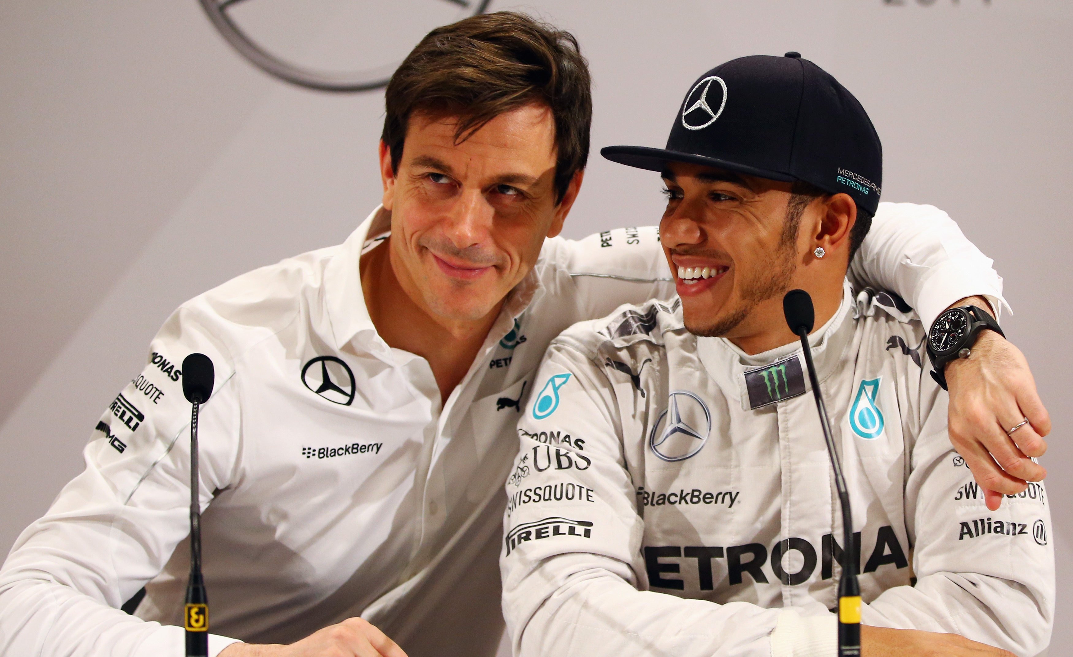 Mercedes F1 racing driver Lewis Hamilton and team CEO Toto Wolff speaking at a press conference